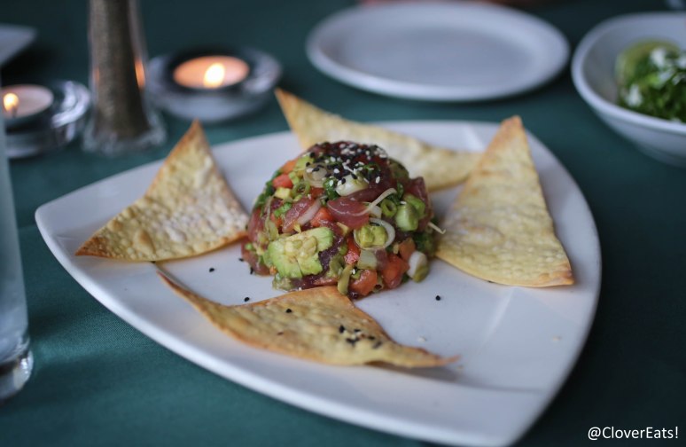 TUNA POKE - FRESH HAWAIIAN AHI TUNA, DICED & TOSSED WITH TOMATOES, SCALLIONS, & AVOCADO IN A YUZU VINAIGRETTE; SERVED ON CRISPY WONTONS WITH WASABI AND GINGER