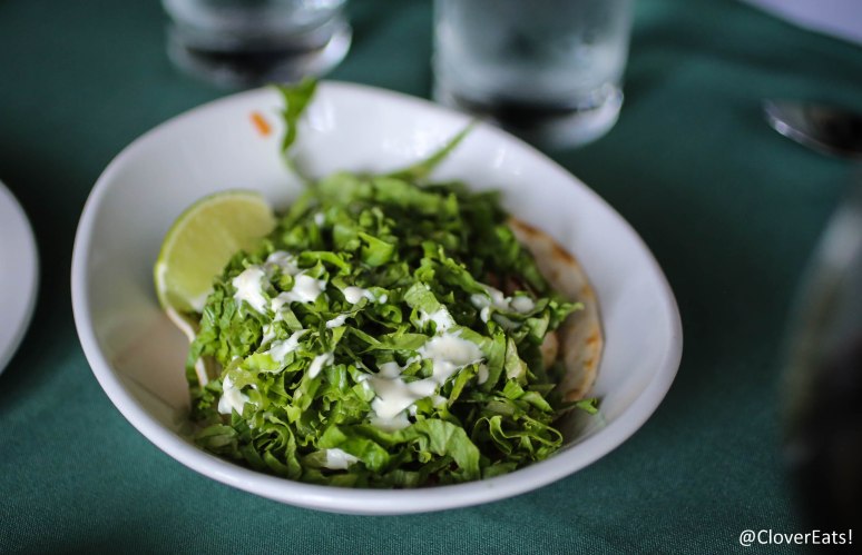 FISH TACO - HALIBUT PIECES LIGHTLY COATED IN FLOUR, PAN-SEARED AND SERVED IN A SOFT FLOUR TORTILLA WITH CILANTRO, TOMATOES, AND A BAJA CREAM; SERVED WITH ROASTED TOMATILLO SALSA