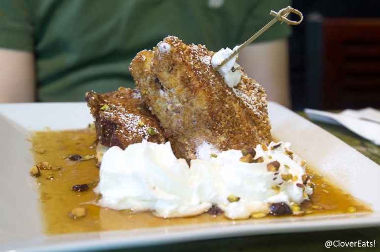 Cannoli French Toast: Texas brioche encrusted in an almost crunch filled with creamy cannoli filling with chocolate chips and pistachios in a brandy maple syrup